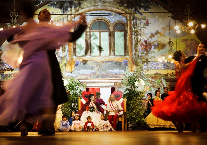 ITALY. Trentino. 2010. In Madonna di Campiglio, during the Habsburg Carneval, dancers enjoying themselves as the "Royal Court" sits and looks on.